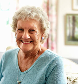 Portrait of happy senior woman in nursing home